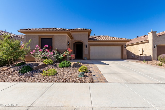 mediterranean / spanish-style home featuring a garage