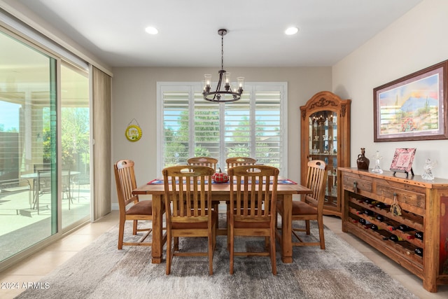 tiled dining space with a notable chandelier