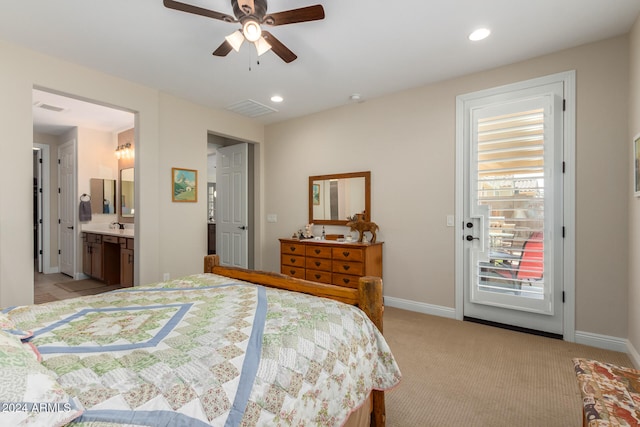 bedroom featuring light carpet, ensuite bathroom, access to exterior, and ceiling fan