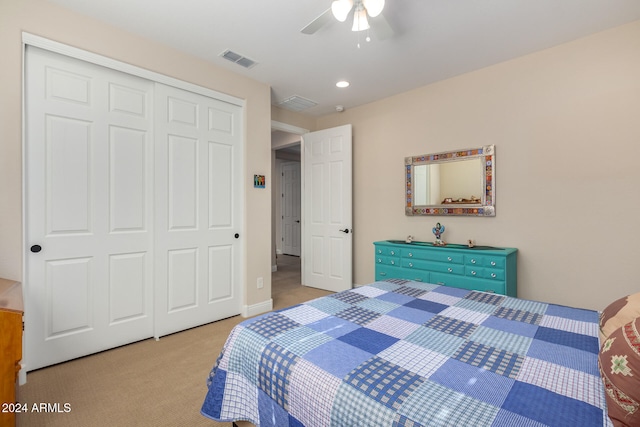 bedroom featuring a closet, ceiling fan, and light colored carpet