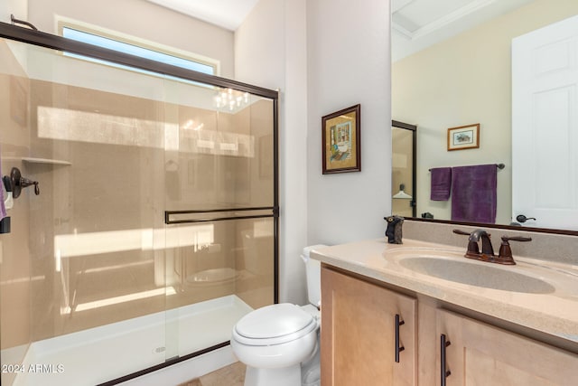 bathroom featuring toilet, walk in shower, and vanity