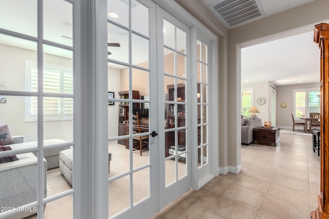 doorway with french doors and light tile patterned floors