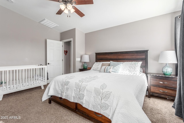 bedroom with vaulted ceiling, light carpet, and ceiling fan