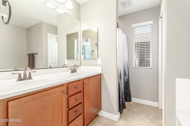 bathroom featuring tile patterned flooring and vanity