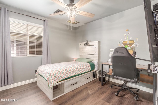 bedroom with ceiling fan and dark hardwood / wood-style floors