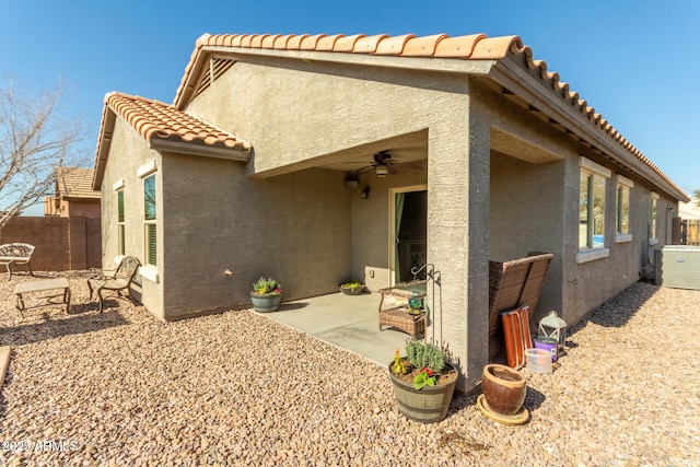 rear view of house featuring central AC, ceiling fan, and a patio area