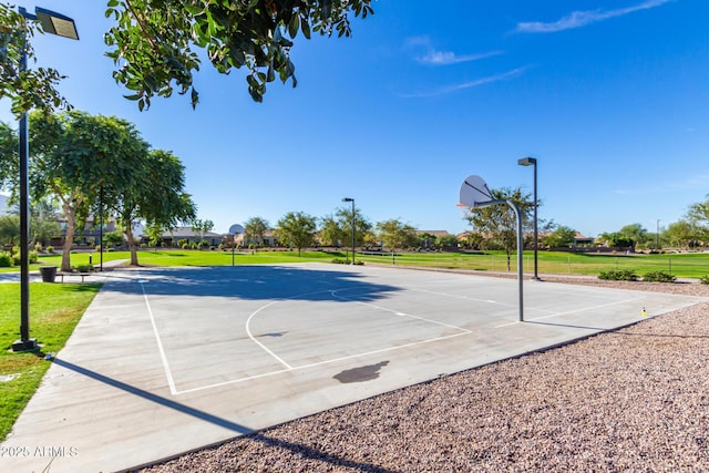 view of sport court featuring a yard