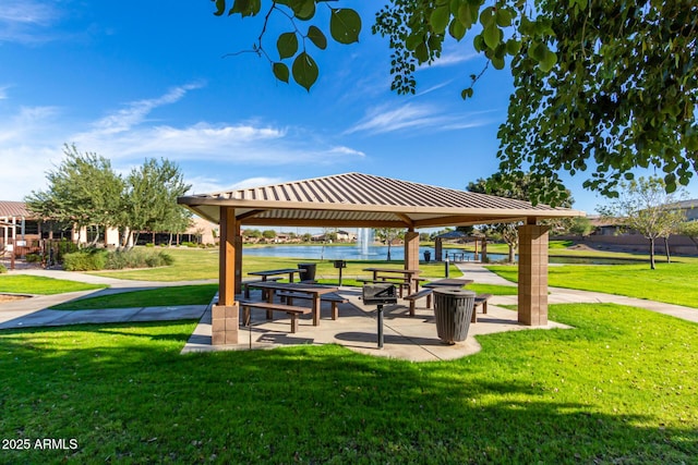 view of home's community featuring a gazebo, a water view, and a yard