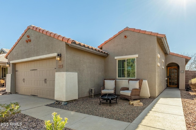 view of front of house featuring a garage and a fire pit