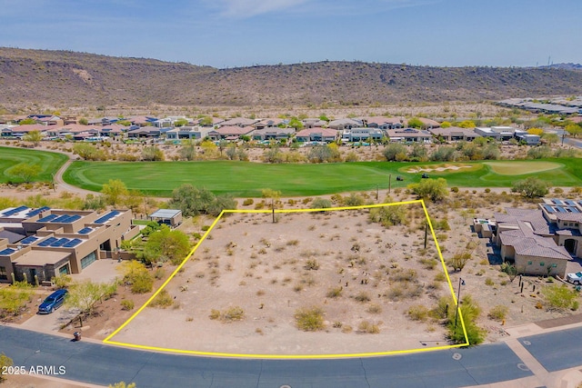 birds eye view of property with a mountain view, a residential view, and view of golf course