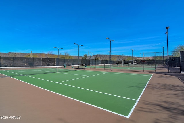view of sport court featuring fence