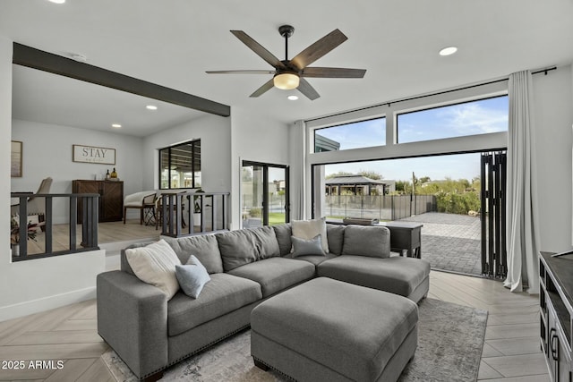 living room featuring ceiling fan, light parquet flooring, and a wealth of natural light