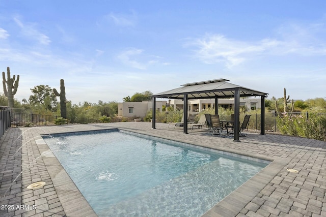 view of swimming pool featuring pool water feature, a patio area, and a gazebo