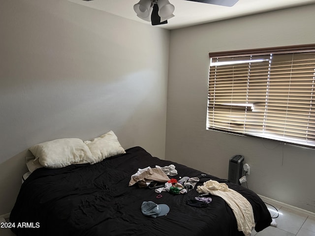 bedroom with ceiling fan and light tile patterned floors