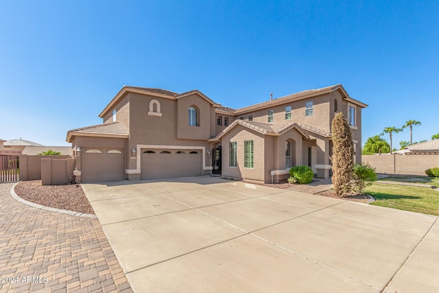 mediterranean / spanish-style home with a garage