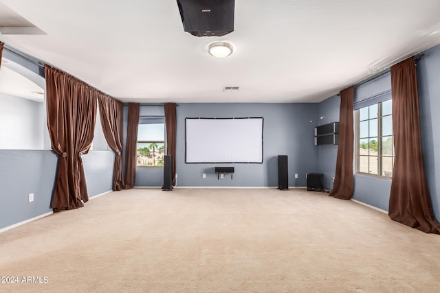 cinema featuring carpet and a wealth of natural light