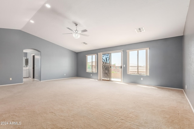 unfurnished room with vaulted ceiling, ceiling fan, and light colored carpet