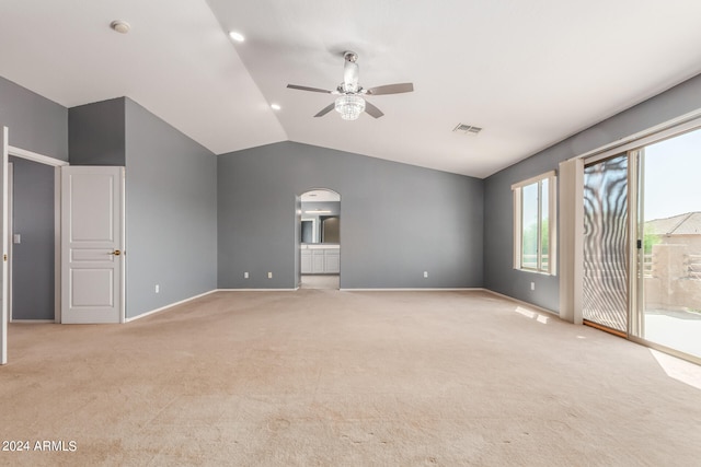 unfurnished room featuring vaulted ceiling, ceiling fan, and light colored carpet