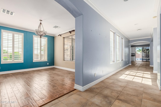 hallway featuring ornamental molding and hardwood / wood-style flooring