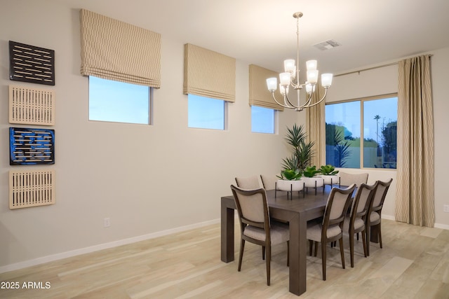 dining room featuring an inviting chandelier and light wood-type flooring