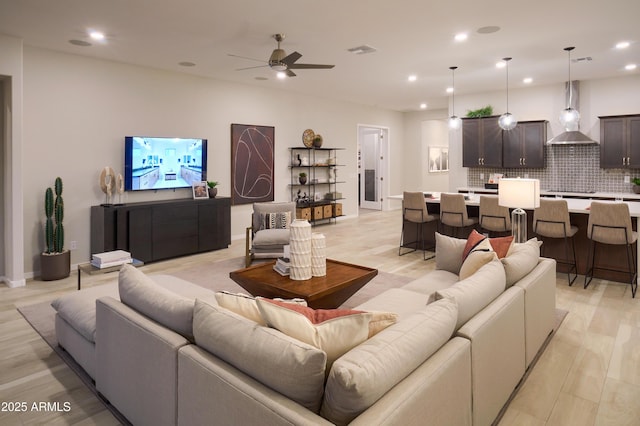 living room featuring ceiling fan and light wood-type flooring