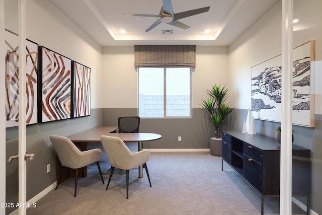 office space featuring ceiling fan, a raised ceiling, and carpet floors