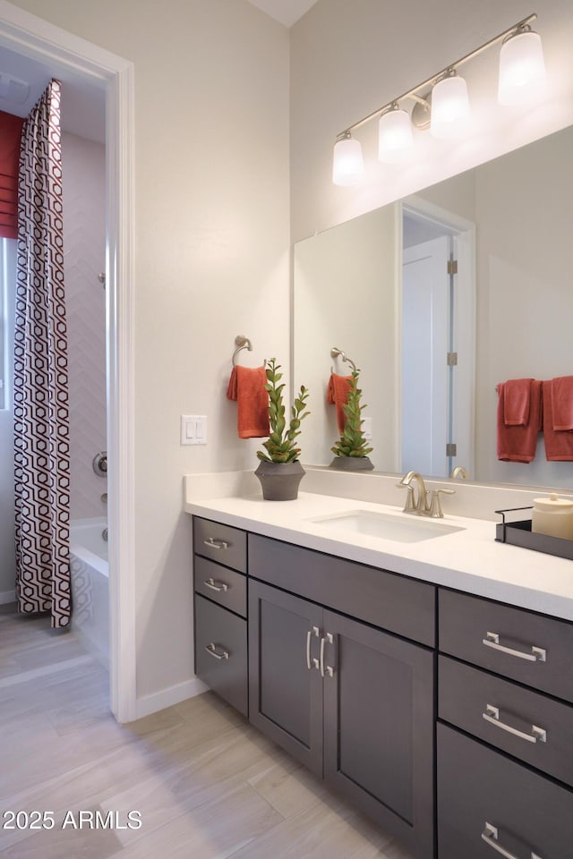 bathroom featuring vanity and shower / bath combo