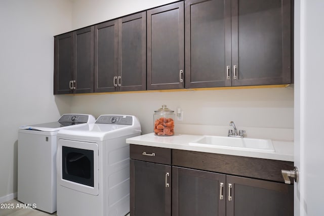 laundry area featuring cabinets, sink, and washer and dryer