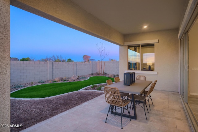 view of patio terrace at dusk