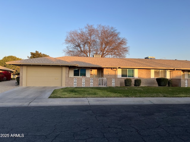 ranch-style house with a garage and a front lawn