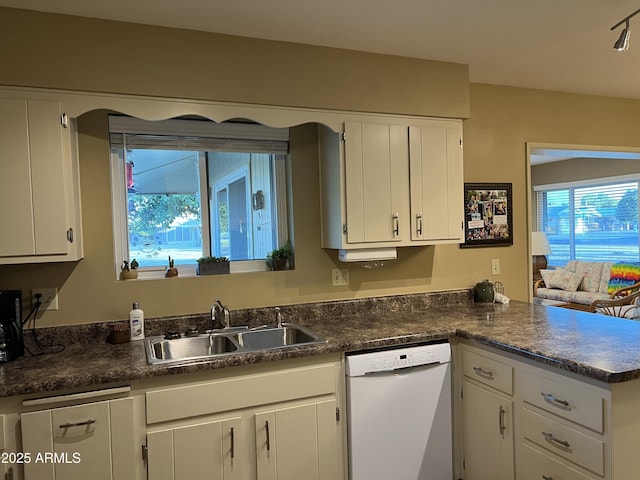 kitchen featuring sink, white cabinets, white dishwasher, and kitchen peninsula