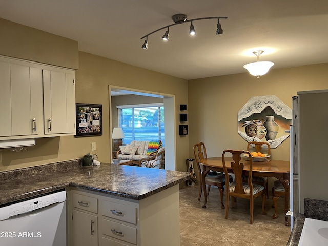 kitchen with dishwasher, kitchen peninsula, and white cabinets