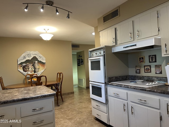 kitchen featuring white appliances and white cabinets