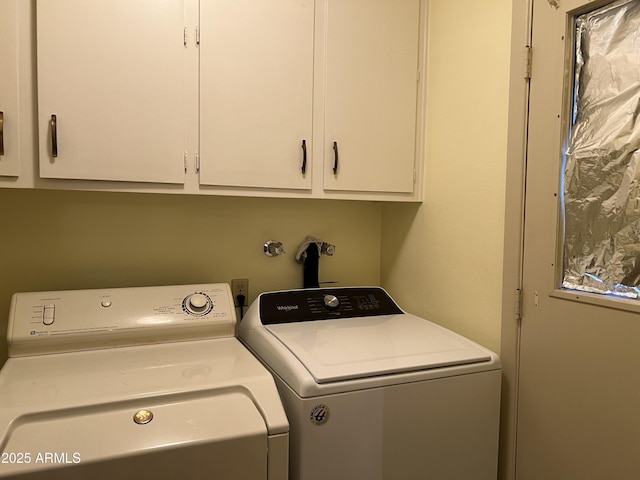 washroom with washer and clothes dryer and cabinets