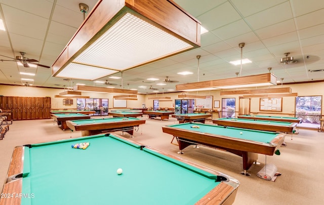 game room featuring a paneled ceiling, carpet flooring, ceiling fan, and billiards