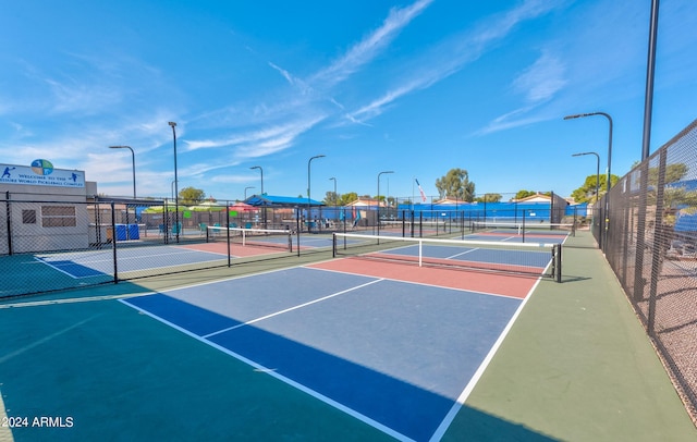 view of tennis court featuring basketball hoop