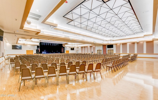 interior space featuring hardwood / wood-style floors and a raised ceiling