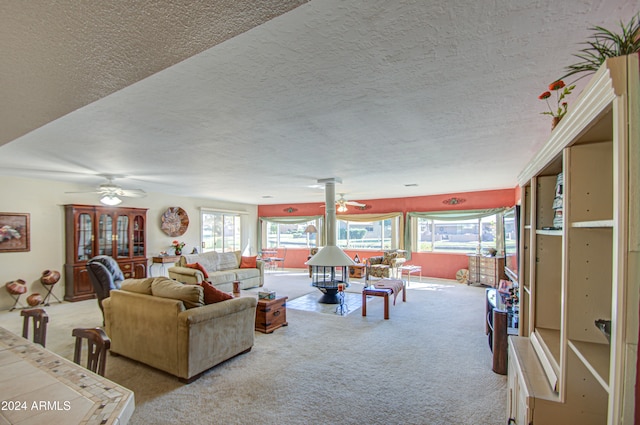 carpeted living room with a textured ceiling and ceiling fan