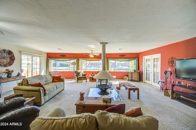 carpeted living room featuring a textured ceiling and ceiling fan