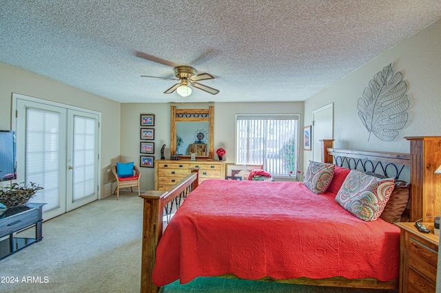 bedroom featuring ceiling fan, access to exterior, a textured ceiling, and carpet