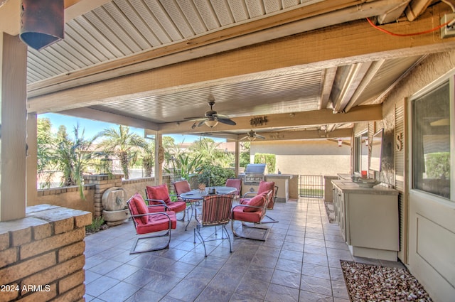 view of patio featuring a grill, an outdoor kitchen, and ceiling fan