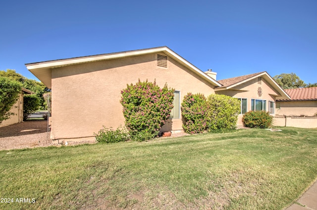 view of home's exterior featuring a lawn