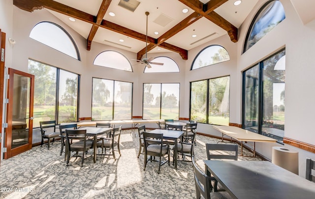 sunroom featuring beamed ceiling, coffered ceiling, and ceiling fan