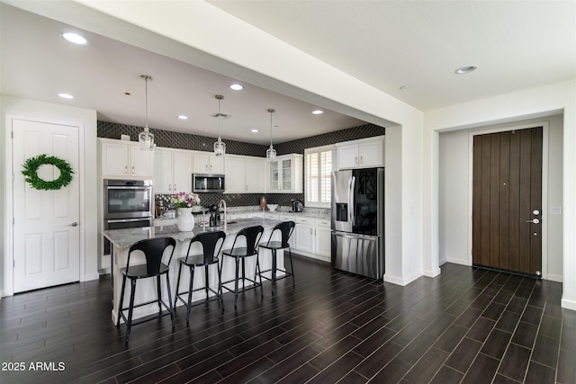 kitchen featuring white cabinets, recessed lighting, appliances with stainless steel finishes, and dark wood-style flooring