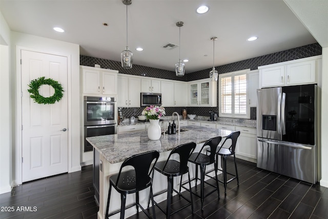 kitchen with white cabinets, dark wood-style floors, and stainless steel appliances