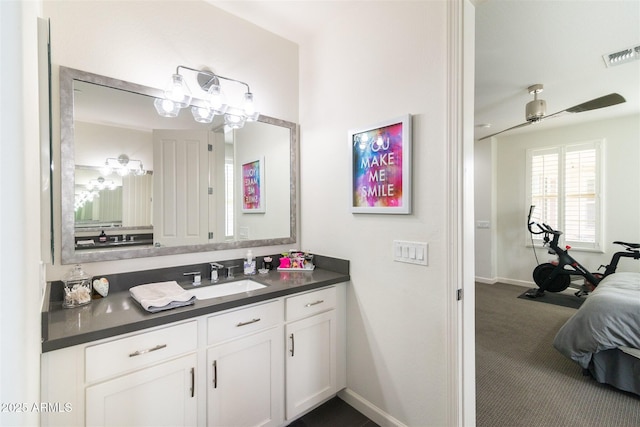 bathroom featuring baseboards, vanity, visible vents, and an inviting chandelier