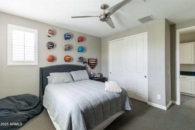 carpeted bedroom with a closet, visible vents, baseboards, and ceiling fan