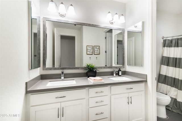 full bath with a sink, a shower with shower curtain, double vanity, and toilet