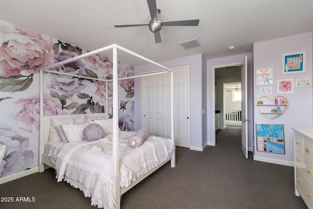 bedroom with visible vents, dark colored carpet, baseboards, and a closet