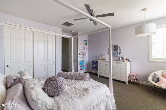 carpeted bedroom featuring baseboards, visible vents, a closet, and ceiling fan